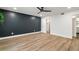 Bright bedroom with wood-look flooring, an accent wall, a ceiling fan, and closet with storage space at 6851 Roswell Rd # N10, Sandy Springs, GA 30328