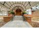 Elegant covered front entrance with brick accents and landscaped features adding to the home's curb appeal at 6851 Roswell Rd # N10, Sandy Springs, GA 30328