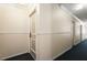 Hallway view featuring carpeting and neutral paint, leading to apartment doors at 6851 Roswell Rd # N10, Sandy Springs, GA 30328