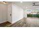 Open-concept room featuring hardwood floors, natural light, and glass doors to the patio at 6851 Roswell Rd # N10, Sandy Springs, GA 30328