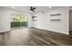 Open living space features hardwood floors, a sliding glass door, and minimalist decor at 6851 Roswell Rd # N10, Sandy Springs, GA 30328