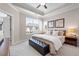 Cozy bedroom with a king-size bed, bench, neutral decor, and abundant natural light from large windows at 710 Hudson Way, Roswell, GA 30076