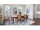 Elegant dining room with a classic table set, hardwood floors, and natural light at 710 Hudson Way, Roswell, GA 30076