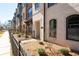 Brick townhome exterior with arched windows and manicured landscaping at 710 Hudson Way, Roswell, GA 30076