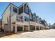 Modern townhome exterior with gray and white color scheme and garage parking at 710 Hudson Way, Roswell, GA 30076