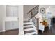 Welcoming foyer featuring a staircase, wood floors, and stylish decor at 710 Hudson Way, Roswell, GA 30076