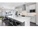 Open kitchen features a large island with bar seating, stainless steel appliances, and hardwood flooring at 710 Hudson Way, Roswell, GA 30076