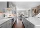 Modern kitchen features stainless steel appliances, ample counter space, and hardwood flooring at 710 Hudson Way, Roswell, GA 30076
