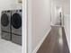 Convenient laundry area with modern, front-loading washer and dryer on a tiled floor at 710 Hudson Way, Roswell, GA 30076