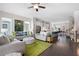 Open-concept living space boasts hardwood floors, neutral paint, large windows, and comfortable seating at 710 Hudson Way, Roswell, GA 30076