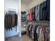 Spacious walk-in closet with ample shelving and hanging space for organized storage of clothes, shoes and accessories at 710 Hudson Way, Roswell, GA 30076