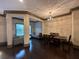 Open-concept dining room featuring wood floors, decorative lighting, and an adjacent sitting area at 745 Fountainhead Ne Ln # 130, Atlanta, GA 30324