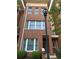 Lovely brick townhome with large windows and a vintage style lamp post at entrance at 745 Fountainhead Ne Ln # 130, Atlanta, GA 30324