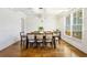 Bright dining room with white wainscoting, hardwood floors, and ample space for entertaining at 2300 Hopehaven Way, Hoschton, GA 30548