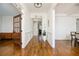 Elegant hallway featuring rich hardwood flooring, decorative molding, and an open, airy feel at 2300 Hopehaven Way, Hoschton, GA 30548