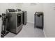 Convenient laundry room featuring modern washer and dryer set, stylish tile floor and laundry organization at 2300 Hopehaven Way, Hoschton, GA 30548