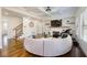 Bright living room featuring hardwood floors, fireplace, and spiral couch in an open layout at 2300 Hopehaven Way, Hoschton, GA 30548