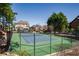 Community tennis court surrounded by lush greenery, well-maintained in a residential area at 2300 Hopehaven Way, Hoschton, GA 30548