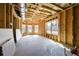 Unfinished room featuring wood-framed walls, a concrete floor and windows to create a light, bright space at 2300 Hopehaven Way, Hoschton, GA 30548