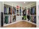 Organized walk-in closet with custom shelving and ample space for clothing and accessories at 2300 Hopehaven Way, Hoschton, GA 30548