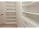 Walk-in closet featuring built-in shelving and drawer storage at 2655 Sarah Carlin Ct, Norcross, GA 30071