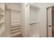 Walk-in closet featuring rods for hanging clothes and built-in shelving at 2655 Sarah Carlin Ct, Norcross, GA 30071