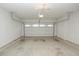 Empty two car garage with concrete floor and white walls at 2655 Sarah Carlin Ct, Norcross, GA 30071