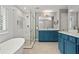 Elegant bathroom with soaking tub, glass-enclosed shower, and blue double vanity at 2782 Loftview Sq, Atlanta, GA 30339