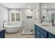 Bathroom featuring a freestanding tub, glass shower, and double vanity with shuttered windows at 2782 Loftview Sq, Atlanta, GA 30339