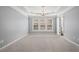 Spacious bedroom with neutral walls, tray ceiling, chandelier, and large windows at 2782 Loftview Sq, Atlanta, GA 30339