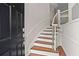 Welcoming foyer showcasing a staircase with wood treads, white risers, decorative railing, and adjacent front door at 2782 Loftview Sq, Atlanta, GA 30339