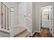 Hallway features a staircase, a door to a closet, and entrance to a stylish bathroom with floral wallpaper at 2782 Loftview Sq, Atlanta, GA 30339