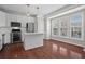 Bright kitchen featuring stainless steel appliances, white cabinets, hardwood floors, and natural light from a nearby window at 2782 Loftview Sq, Atlanta, GA 30339