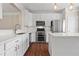 Spacious kitchen featuring stainless steel appliances, white cabinetry, a center island, and hardwood floors at 2782 Loftview Sq, Atlanta, GA 30339