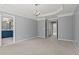 Large bedroom with trey ceiling and doorway view to a bright bathroom at 2782 Loftview Sq, Atlanta, GA 30339