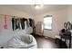 Bright bedroom with hardwood floors, dresser and makeup vanity with decorative mirror at 41 Silverthorne Ct, Douglasville, GA 30134