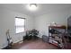 Bedroom with hardwood floors, large window, desk, and shelving at 41 Silverthorne Ct, Douglasville, GA 30134