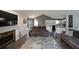 Bright living room with a fireplace, hardwood floors, modern sofas and a kitchen view at 41 Silverthorne Ct, Douglasville, GA 30134