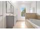 Bright bathroom with tiled bathtub, double vanity, and natural light at 849 Perennial Dr, Atlanta, GA 30328