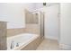 Bathroom features tiled soaking tub with shower at 849 Perennial Dr, Atlanta, GA 30328