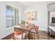 Cozy dining area featuring modern lighting, a flower-themed print, and stainless steel refrigerator at 849 Perennial Dr, Atlanta, GA 30328