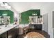 This bathroom features an accent wall of shrubbery, double sinks, and dark wood cabinets at 367 Reserve Overlook, Canton, GA 30115