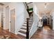 Hallway with hardwood floors, staircase, and decorated with artistic details at 367 Reserve Overlook, Canton, GA 30115