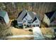 Aerial view of a two-story home with lush landscaping and a two-car garage at 3966 Creekview Ridge Dr, Buford, GA 30518