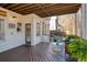 Inviting back porch with dark plank floor, exterior lighting, and comfortable seating area at 3966 Creekview Ridge Dr, Buford, GA 30518