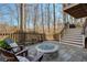 Backyard with fire pit, chairs and staircase leading up to the deck at 3966 Creekview Ridge Dr, Buford, GA 30518