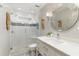 Modern bathroom featuring a glass shower, a decorative seahorse, and a round, decorative mirror at 3966 Creekview Ridge Dr, Buford, GA 30518