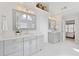 Bright bathroom featuring marble floors, double vanities, modern lighting, and a view into the main bedroom at 3966 Creekview Ridge Dr, Buford, GA 30518