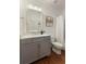 Well-lit bathroom with a gray vanity and framed mirror at 3966 Creekview Ridge Dr, Buford, GA 30518