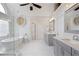 Bright bathroom features a modern tub, glass shower, double vanity with stone countertops and updated fixtures at 3966 Creekview Ridge Dr, Buford, GA 30518